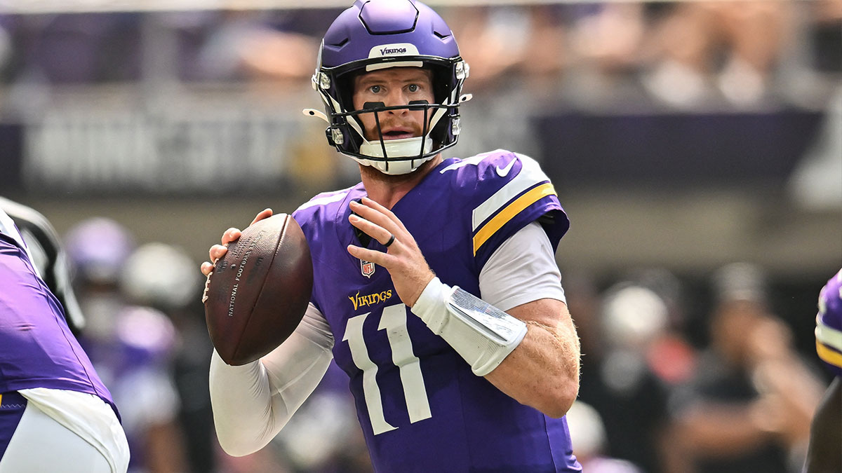Minnesota Vikings quarterback Carson Wentz (11) looks to throws a pass against the Baltimore Ravens during the second quarter at U.S. Bank Stadium. 