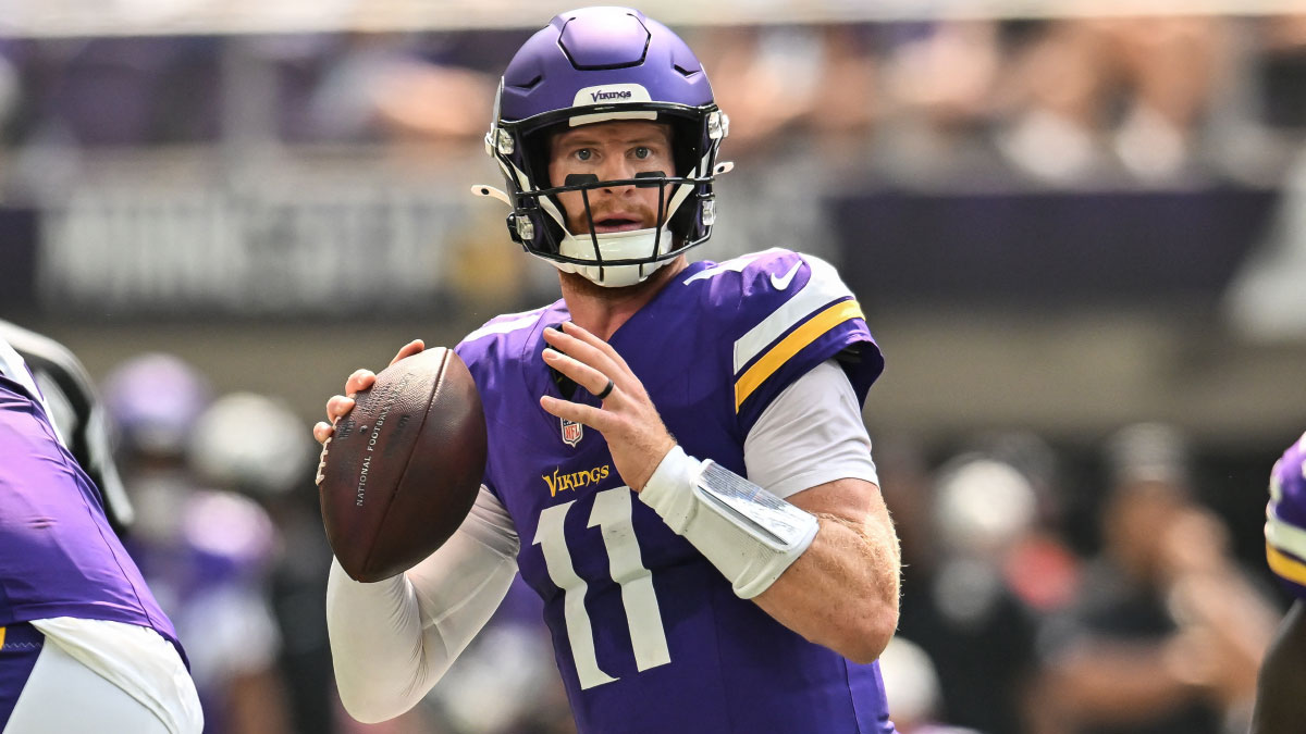 Minnesota Vikings quarterback Carson Wentz (11) looks to throws a pass against the Baltimore Ravens during the second quarter at U.S. Bank Stadium. 