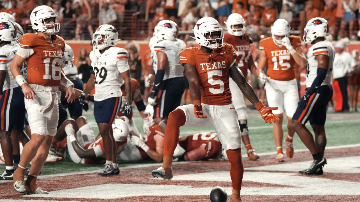 Texas Longhorns running back Derrek Cooper (5) reacts ahead of quarterback Arch Manning (16) after running for his first collegiate touchdown during the second half against the UTSA Roadrunners at Darrell K Royal-Texas Memorial Stadium. 