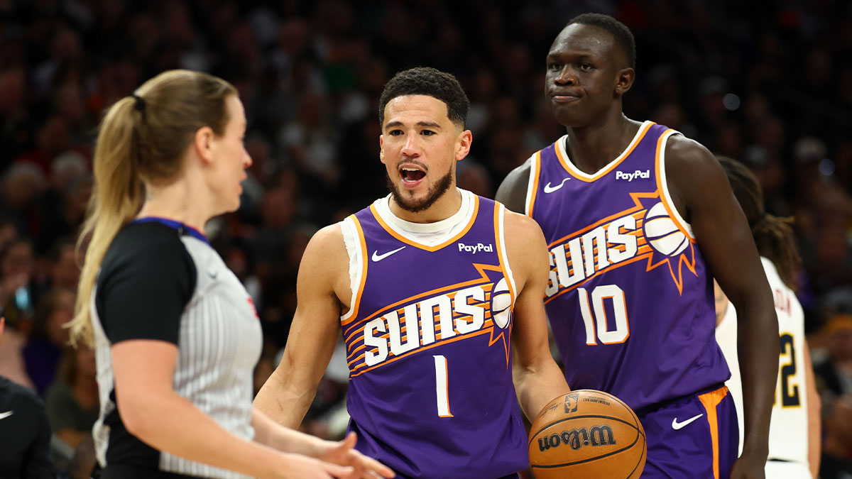 Phoenix Suns guard Devin Booker (1) argues with a referee alongside center Khaman Maluach (10) against the Denver Nuggets in the second half at Mortgage Matchup Center.