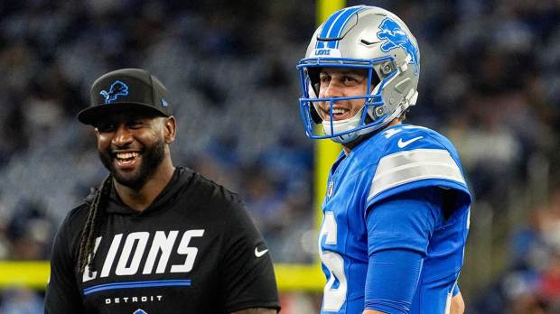 Detroit Lions quarterback Jared Goff (16), talks to defensive coordinator Kelvin Sheppard at warm up ahead of the New Orleans Saints game at Ford Field in Detroit on Sunday, Sept. 13, 2026.