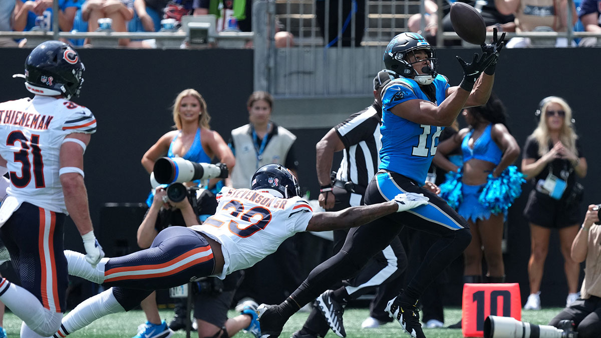 Sep 13, 2026; Charlotte, North Carolina, USA; Carolina Panthers wide receiver Jalen Coker (18) catches the ball while defended by Chicago Bears defensive back Tyrique Stevenson (29) in the second quarter at Bank of America Stadium. 
