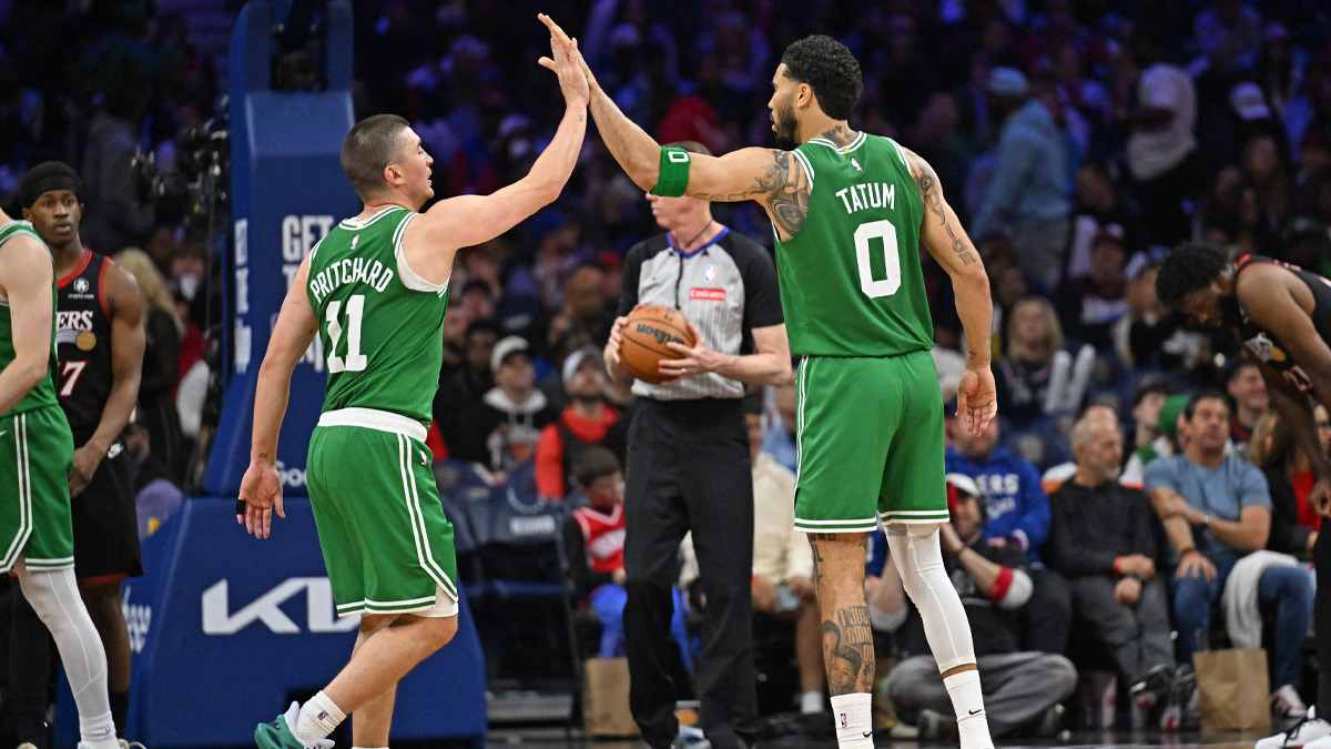 Boston Celtics guard Payton Pritchard (11) and forward Jayson Tatum (0) high five each other after a basket against the Philadelphia 76ers during the second half at Xfinity Mobile Arena.
