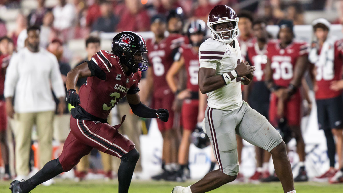 Mississippi State Bulldogs quarterback Kamario Taylor (1) scrambles past South Carolina Gamecocks defensive back Kelvin Hunter (3) in the second half at Williams-Brice Stadium. 