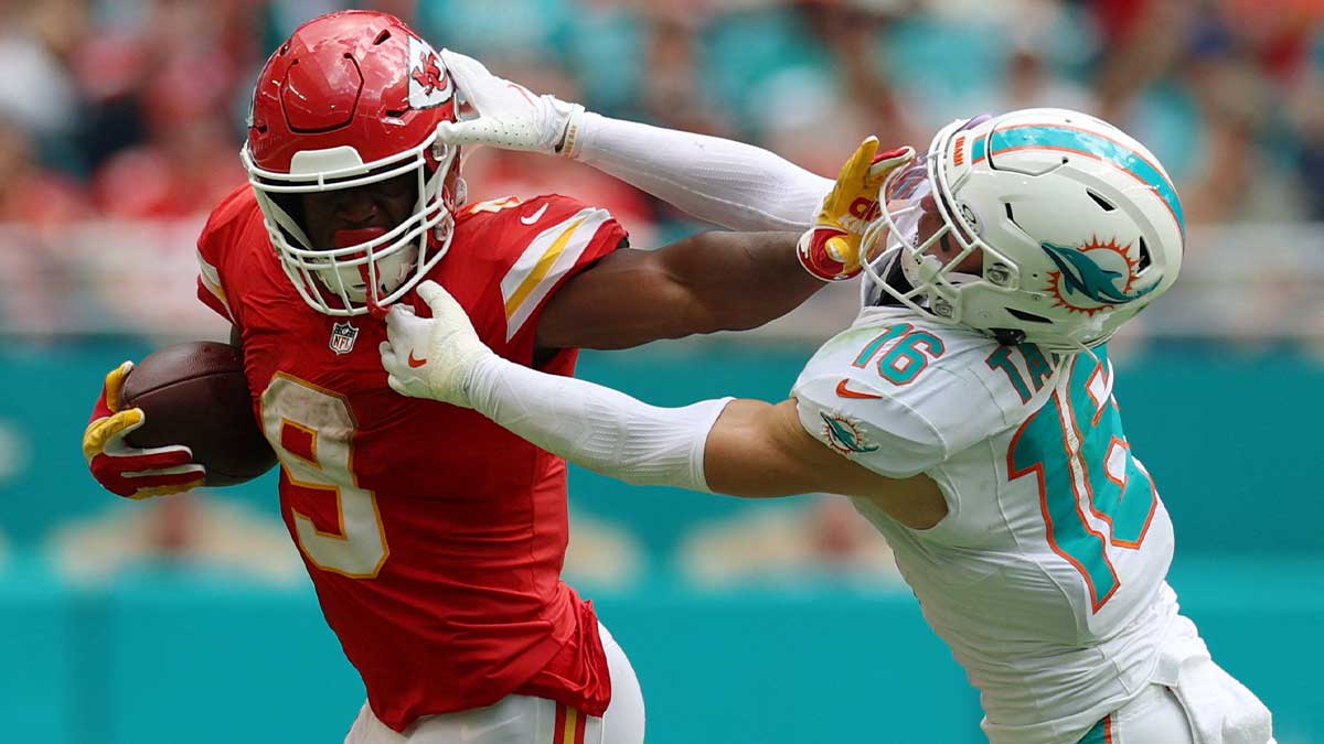 Sep 27, 2026; Miami Gardens, Florida, USA; Kansas City Chiefs running back Kenneth Walker III (9) stiff arms Miami Dolphins safety Michael Taaffe (16) during the fourth quarter at Hard Rock Stadium.
