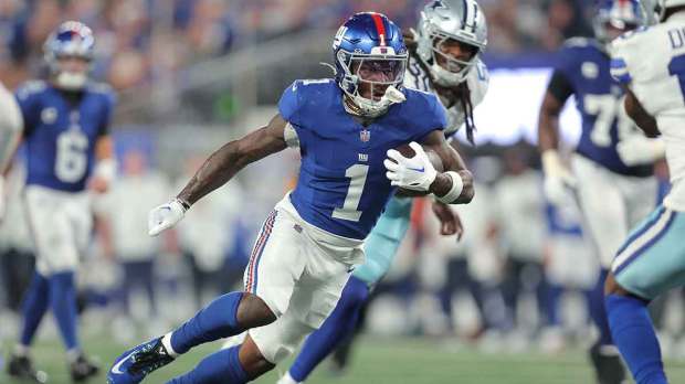 New York Giants wide receiver Malik Nabers (1) carries the ball against the Dallas Cowboys during the third quarter at MetLife Stadium.