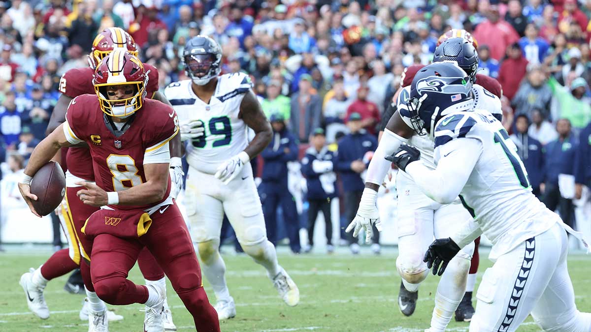 Washington Commanders quarterback Marcus Mariota (8) rushes the ball against the Seattle Seahawks in the second half at Northwest Stadium.