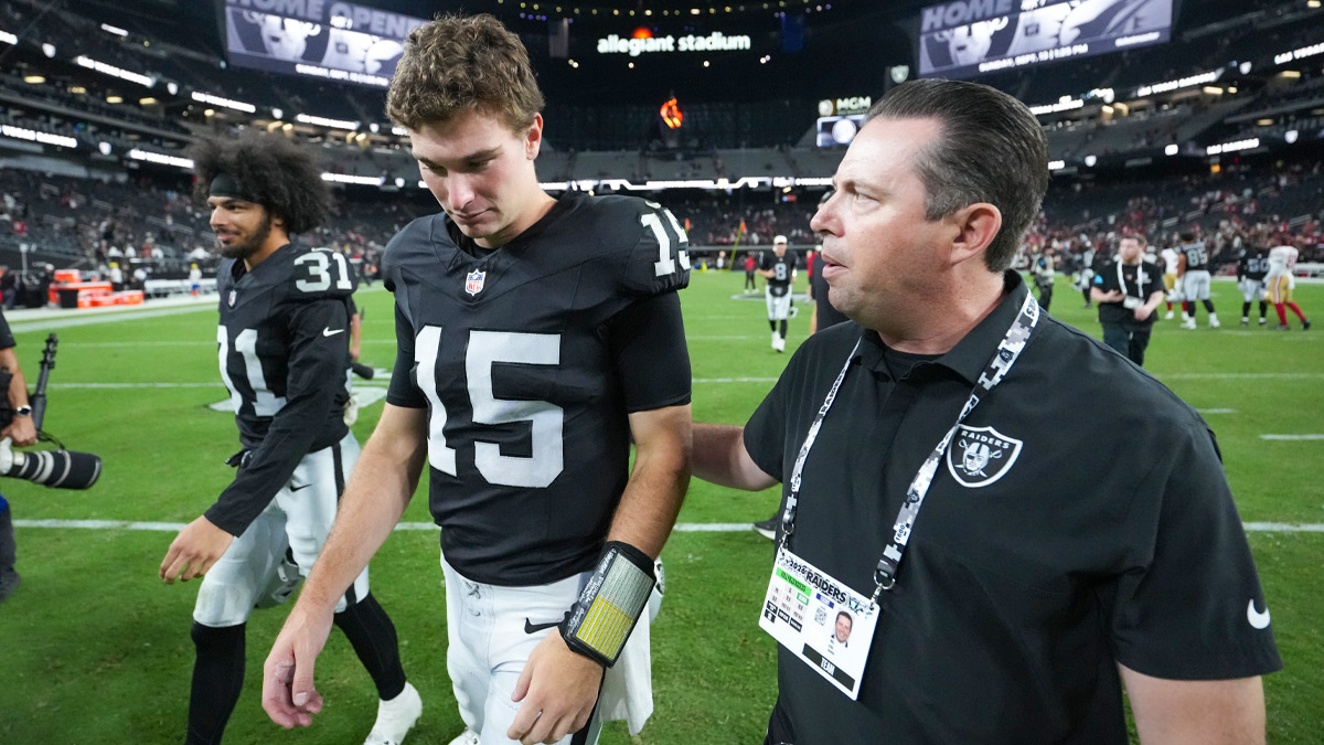 Las Vegas Raiders communications vice president Will Kiss escorts quarterback Fernando Mendoza (15) and safety Treydan Stukes (31) after the game against the San Francisco 49ers at Allegiant Stadium.
