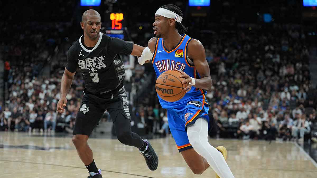 https://wp.clutchpoints.com/wp-content/uploads/2026/09/Oklahoma-City-Thunder-guard-Shai-Gilgeous-Alexander-2-dribbles-past-San-Antonio-Spurs-guard-Chris-Paul-3-in-the-second-half-at-Frost-Bank-Center.jpg