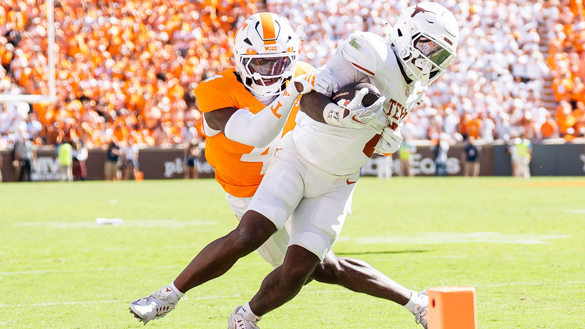 Tennessee defensive back Ty Redmond (4) takes down Texas running back Raleek Brown (0) during a college football game between Tennessee and Texas at Neyland Stadium in Knoxville, Tenn.