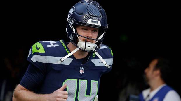 Seattle Seahawks quarterback Sam Darnold (14) takes the field for warm ups before a game against the New England Patriots at Lumen Field.