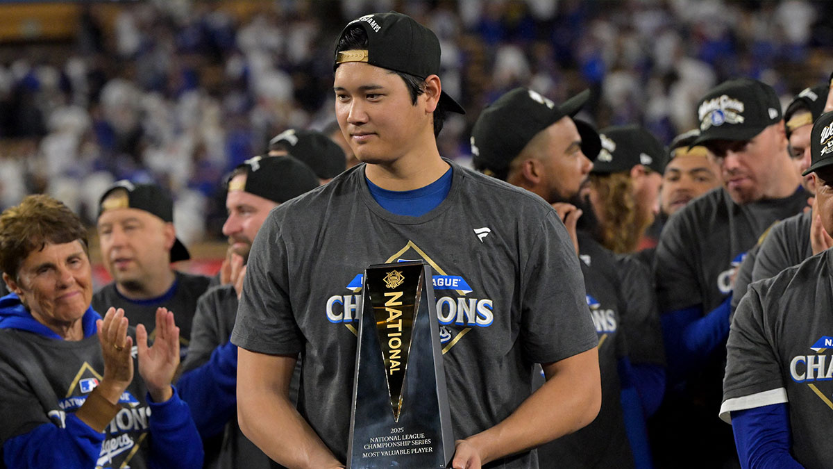 Los Angeles Dodgers two-way player Shohei Ohtani (17) holds the MVP trophy after defeating the Milwaukee Brewers in game five of the NLCS during the 2025 MLB playoffs at Dodger Stadium. 