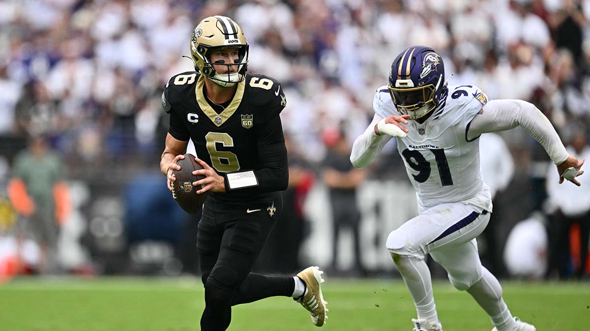 Sep 20, 2026; Baltimore, Maryland, USA; New Orleans Saints quarterback Tyler Shough (6) runs with the ball while under pressure by Baltimore Ravens linebacker Trey Hendrickson (91) in the second quarter at M&T Bank Stadium.