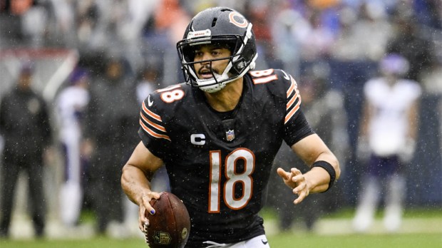 Chicago Bears quarterback Caleb Williams (18) scrambles against the Minnesota Vikings during the second half at Soldier Field.