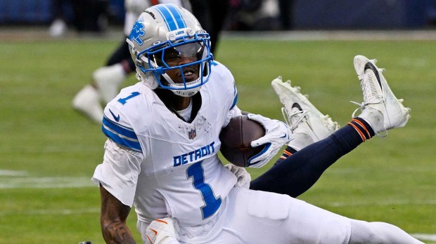 Chicago Bears cornerback Nahshon Wright (26) tackles Detroit Lions wide receiver Jameson Williams (1) during the first half at Soldier Field.