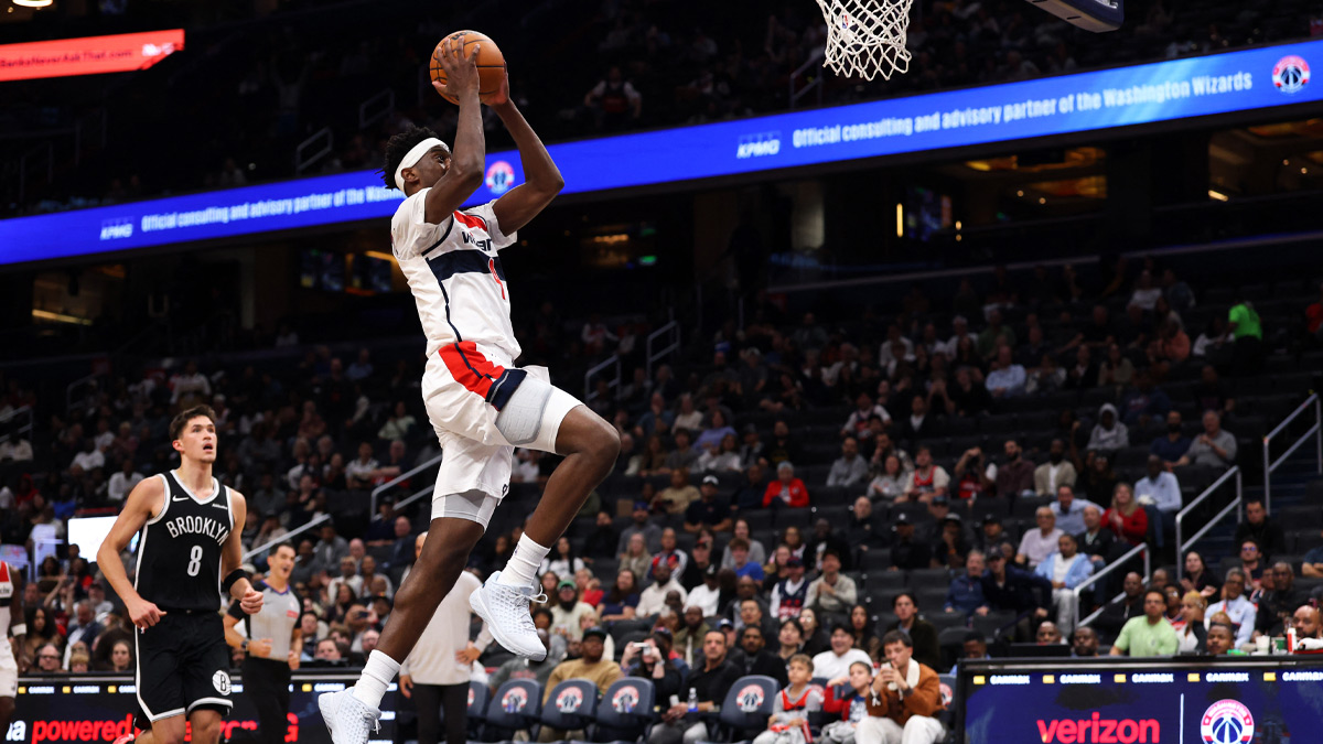 Washington Wizards forward AJ Dybantsa (4) dunks the ball as Brooklyn Nets guard Egor Demin (8) looks on in the second half at Capital One Arena.