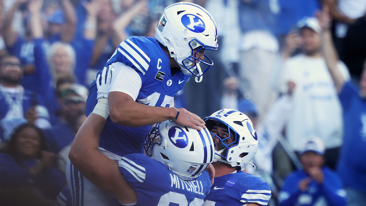 Brigham Young Cougars quarterback Bear Bachmeier (47) celebrates with offensive line Bruce Mitchell (63) after scoring a touchdown against the Notre Dame Fighting Irish during the first halfat LaVell Edwards Stadium.