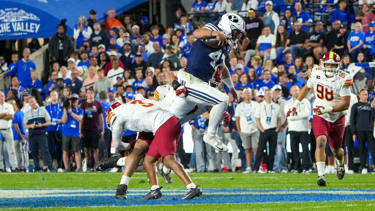 BYU Cougars quarterback Bear Bachmeier (47) jumps over Iowa State Cyclones cornerback Seth Johnson (3) during the first half at LaVell Edwards Stadium.