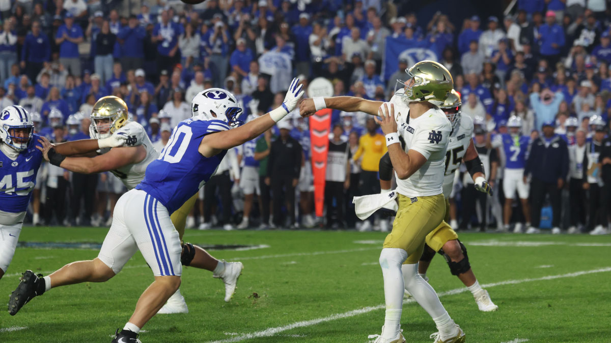 Notre Dame Fighting Irish quarterback CJ Carr (13) passes against Brigham Young Cougars defensive end Hunter Clegg (90) during the first half at LaVell Edwards Stadium.