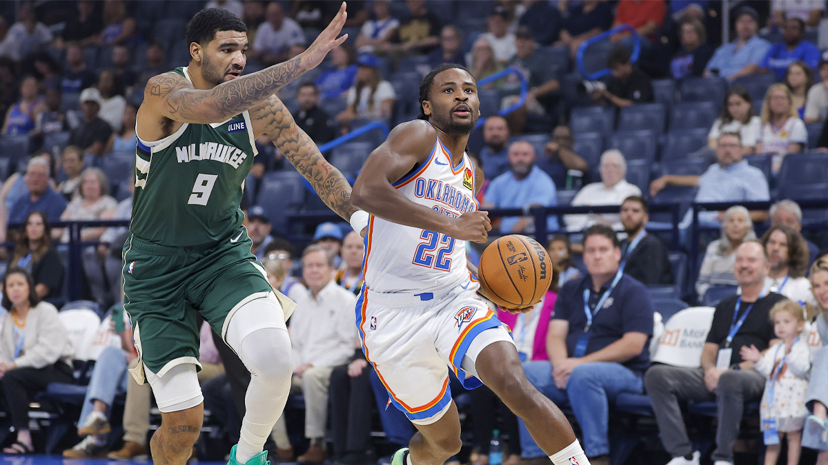 Oklahoma City Thunder guard Cason Wallace (22) drives to the basket past Milwaukee Bucks center Kel'el Ware (9) during the first half of a preseason game at Paycom Center.