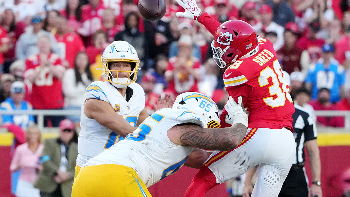 Los Angeles Chargers quarterback Justin Herbert (10) throws a pass as Kansas City Chiefs cornerback L'Jarius Sneed (38) attempts to block during the third quarter at GEHA Field at Arrowhead Stadium.