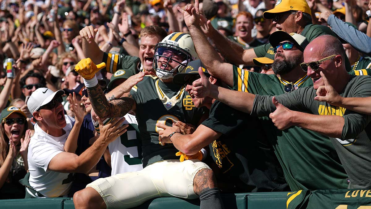 Week 5: Green Bay Packers wide receiver Christian Watson does a Lambeau Leap after scoring a touchdown against the Chicago Bears at Lambeau Field. The Packers defeated the Bears, 31-7.