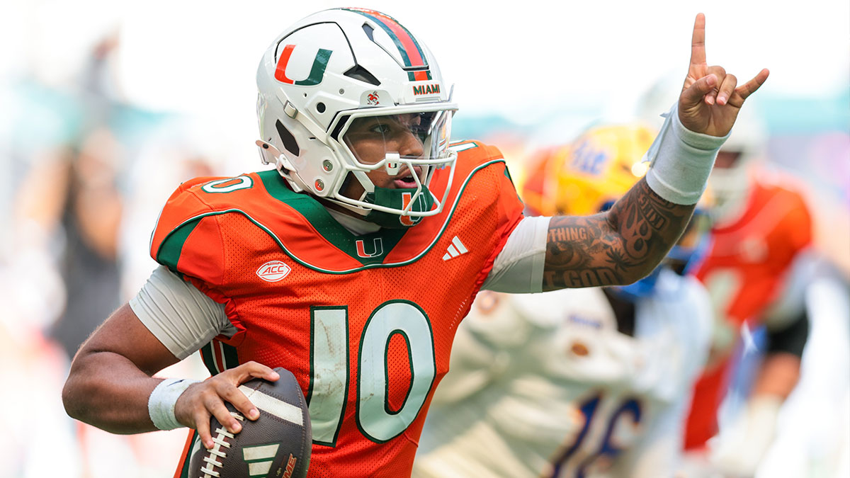 Miami Hurricanes quarterback Darian Mensah (10) runs with the football against the Pittsburgh Panthers during the third quarter at Hard Rock Stadium