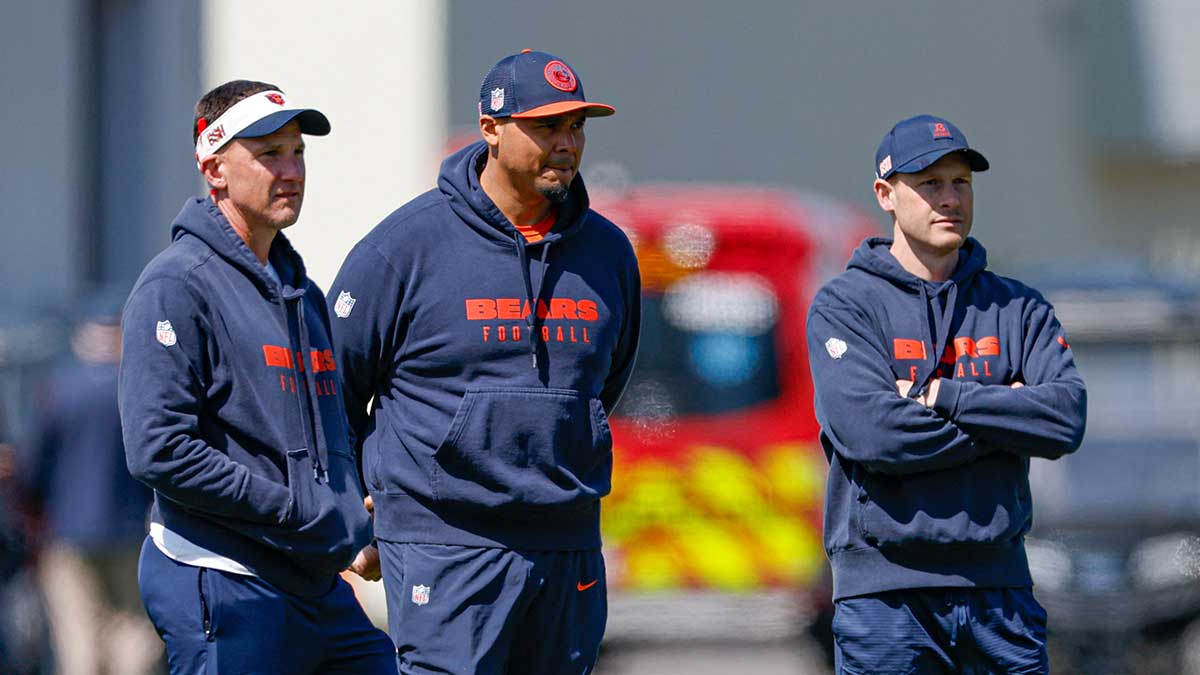 Chicago Bears defensive coordinator Dennis Allen (L), general manager Ryan Poles (C) and head coach Ben Johnson (R) observe during the Rookie Minicamp at Halas Hall.