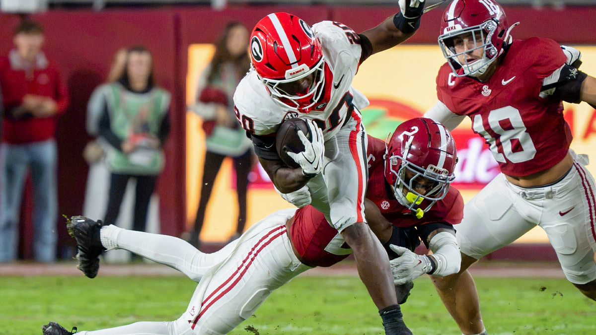 Georgia running back Dwight Phillips Jr. tries to avoid the tackle attempt of Alabama defensive back Zabien Brown (2) at Saban Field at Bryant-Denny Stadium.