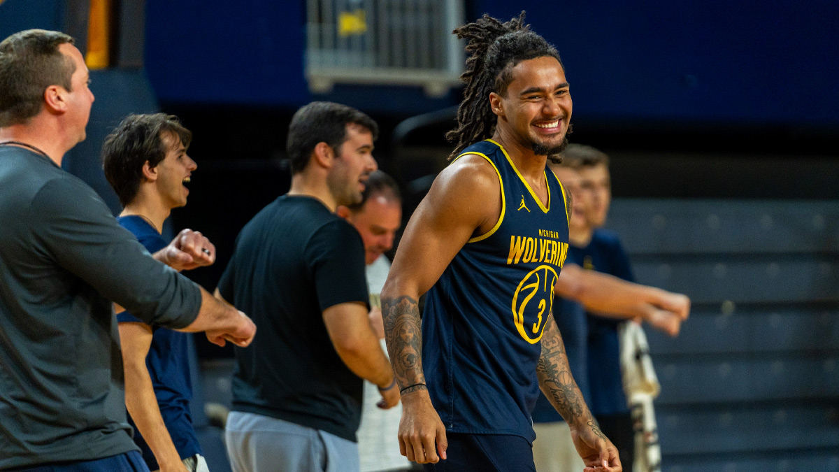 Michigan guard Elliot Cadeau (3) smiles alongside teammates during the Wolverines' men's basketball media day practice at Crisler Center in Ann Arbor on Thursday, Oct. 22, 2026.