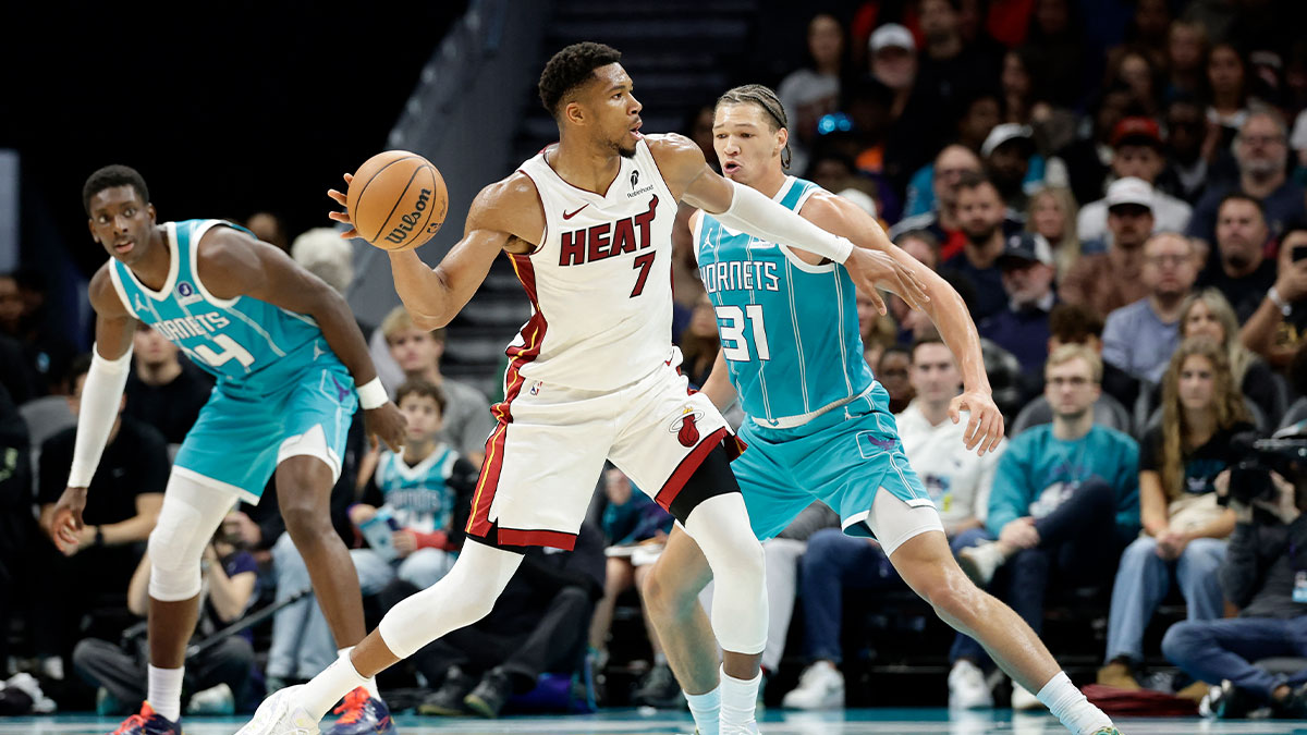 Miami Heat forward Giannis Antetokounmpo (7) passes the ball while being guarded by Charlotte Hornets forward Tidjane Salaun (31) during the second quarter at Spectrum Center.