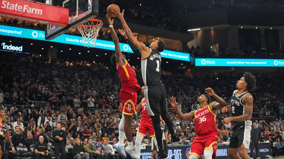 Houston Rockets guard Amen Thompson (1) blocks the final shot attempt by San Antonio Spurs forward Victor Wembanyama (1) at the end of the game at Moody Center.