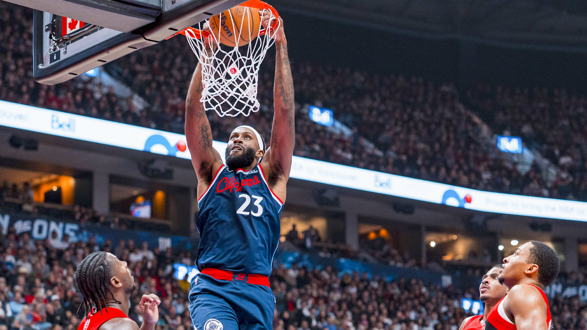 Los Angeles Clippers forward Isaiah Jackson (23) dunks in front of Toronto Raptors guard Jaden Bradley (8) and Nimari Burnett (25) in the first half at Rogers Arena.
