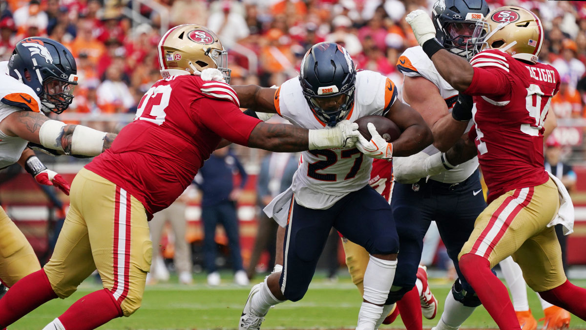 Denver Broncos running back J.K. Dobbins (27) carries the ball as San Francisco 49ers defensive tackle Gracen Halton (93) attempts to make a tackle during the second half at Levi's Stadium.