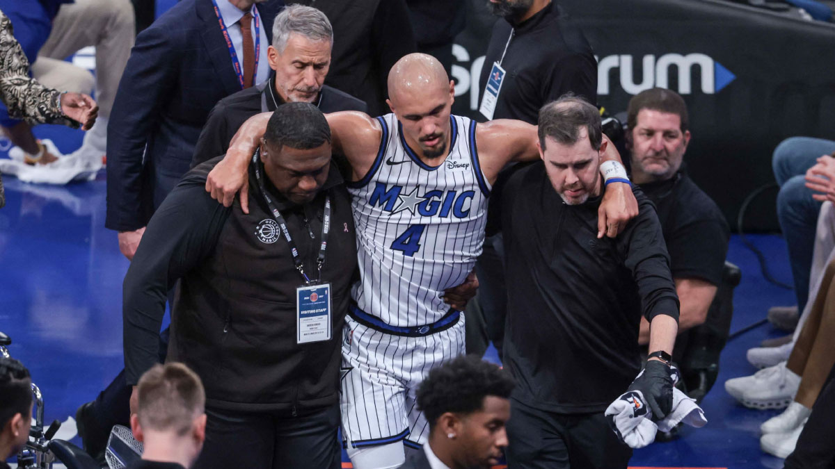 Orlando Magic guard Jalen Suggs (4) is helped off the court after an injury in the fourth quarter against the New York Knicks at Madison Square Garden.