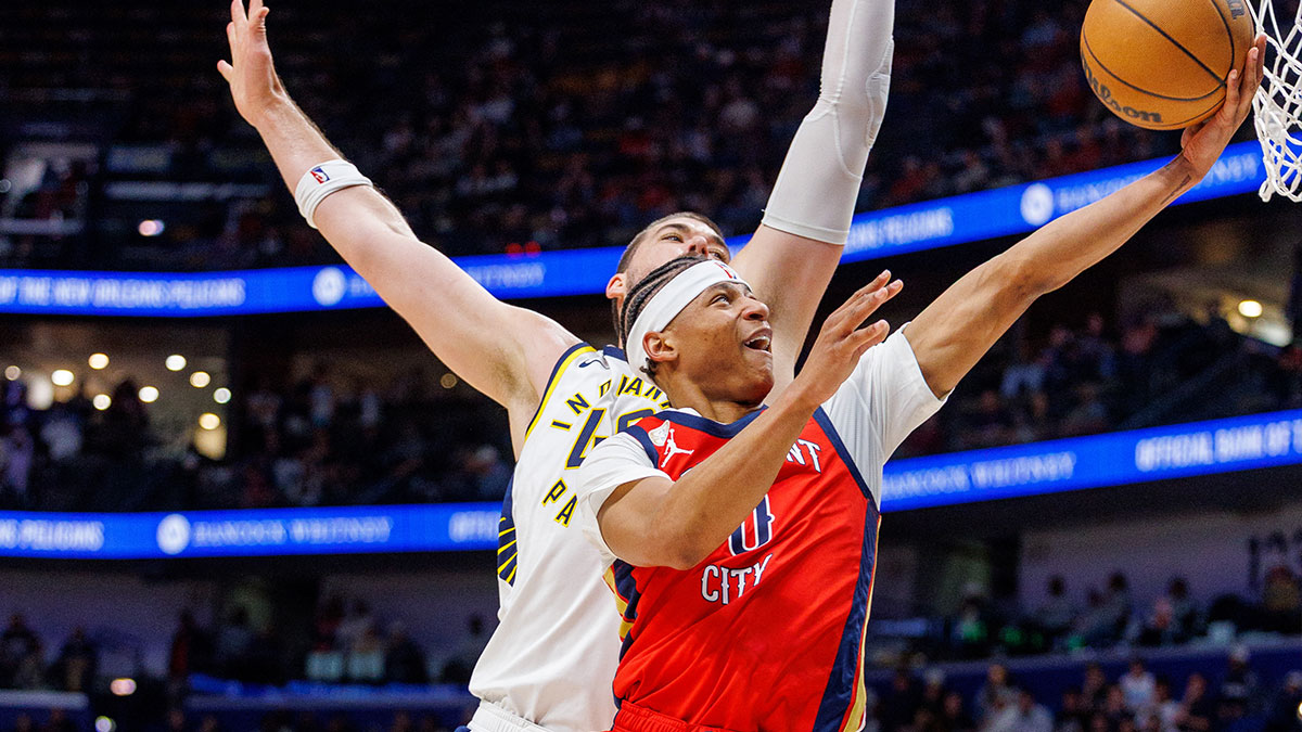New Orleans Pelicans guard Jeremiah Fears (0) drives to the basket against Indiana Pacers center Ivica Zubac (40) during the second half at Smoothie King Center.