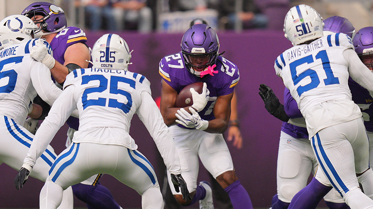 Minnesota Vikings running back Jordan Mason (27) rushes the ball against the Indianapolis Colts in the first half at U.S. Bank Stadium.