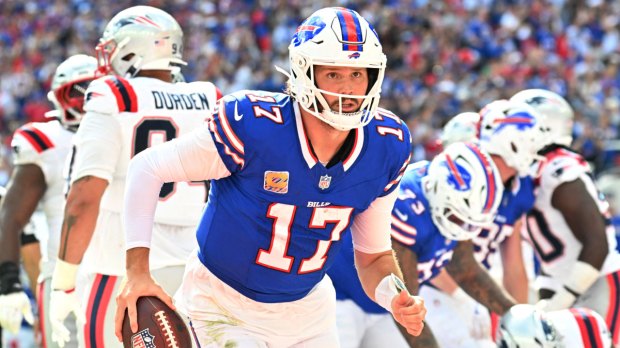 Buffalo Bills quarterback Josh Allen (17) celebrates after scoring a touchdown during the second quarter against the New England Patriots at New Highmark Stadium.