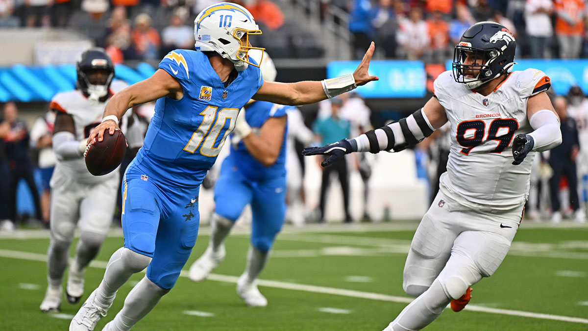 Los Angeles Chargers quarterback Justin Herbert (10) is pressured by Denver Broncos defensive end Zach Allen (99) during the second half at SoFi Stadium.