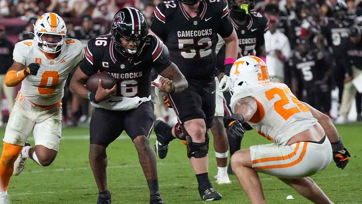 South Carolina Gamecocks quarterback LaNorris Sellers (16) tries to elude Tennessee Volunteers defensive back Sidney Walton (23) during the second half at Williams-Brice Stadium. Mandatory Credit: Jim Dedmon-Imagn Images