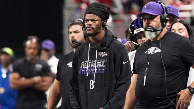Baltimore Ravens quarterback Lamar Jackson (8) on the sidelines during the first quarter against the Atlanta Falcons at Mercedes-Benz Stadium.