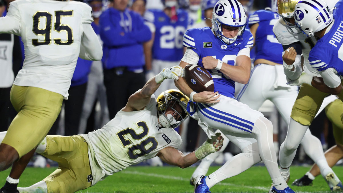 Notre Dame Fighting Irish safety Luke Talich (28) tackles Brigham Young Cougars wide receiver Tiger Bachmeier (19) during the second half at LaVell Edwards Stadium.