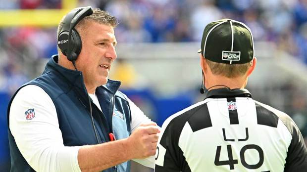 New England Patriots head coach Mike Vrabel speaks with line judge Brian Bolinger (40) during the third quarter against the Buffalo Bills at New Highmark Stadium.