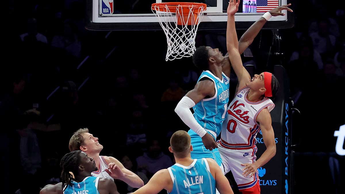 Brooklyn Nets guard Mikel Brown Jr. (0) drives to the basket against Charlotte Hornets guard Dennis Schroder (17) and center Ryan Kalkbrenner (11) during the second quarter at Barclays Center.