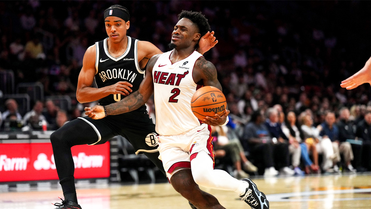 Miami Heat guard Davion Mitchell (2) drives past Brooklyn Nets guard Mikel Brown Jr. (0) during the second half at Kaseya Center.