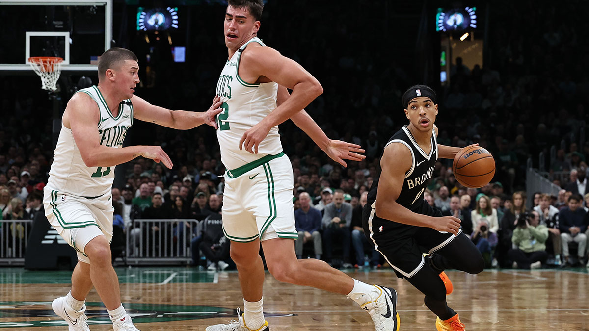 Brooklyn Nets guard Mikel Brown Jr. (0) goes around Boston Celtics center Luka Garza (52) and guard Payton Pritchard (11) during the second half at TD Garden.