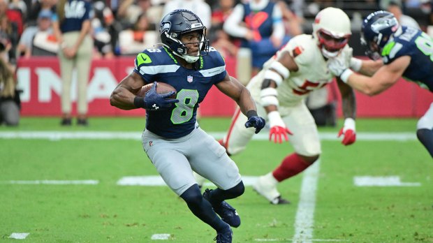 Seattle Seahawks running back Jadarian Price (8) runs with the ball in the first half against the Arizona Cardinals at State Farm Stadium.