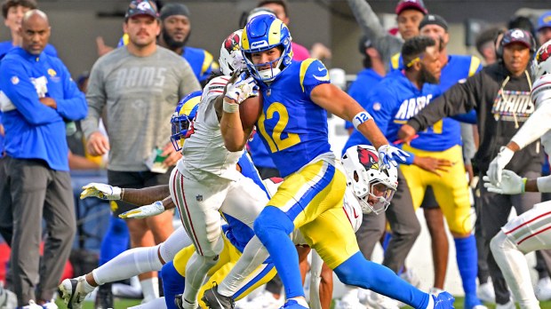 Los Angeles Rams wide receiver Puka Nacua (12) runs for 22 yards after a complete pass against the Arizona Cardinals at SoFi Stadium.