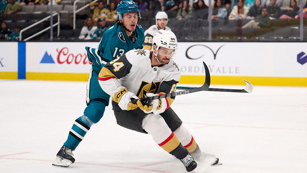 Vegas Golden Knights defenseman Jeremy Davies (84) controls the puck against San Jose Sharks left wing Quentin Musty (13) during the second period at SAP Center at San Jose.