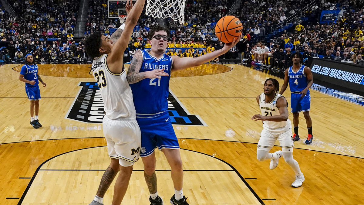 Saint Louis Billikens center Robbie Avila (21) shoots a layup against Michigan Wolverines forward Yaxel Lendeborg (23) during the first half of the second round game of the men's 2026 NCAA Tournament at Keybank Center.